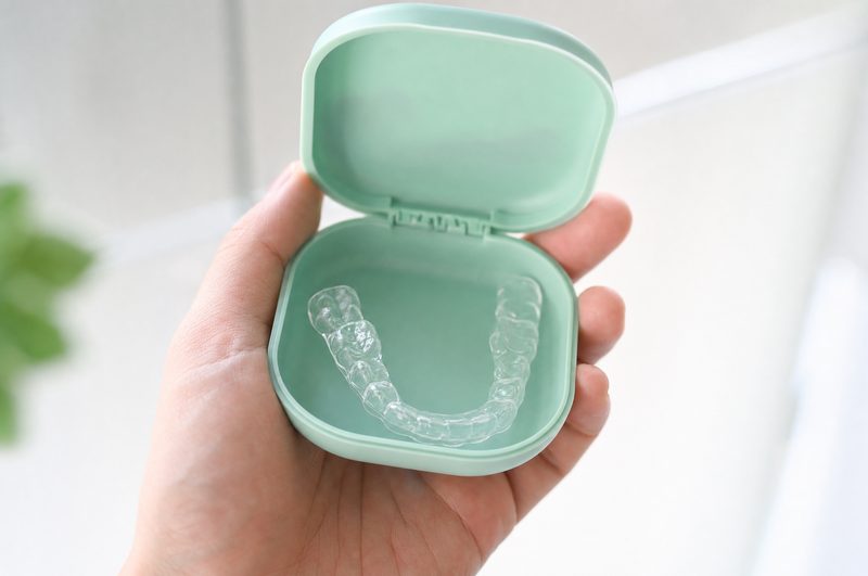 A clear retainer in its case