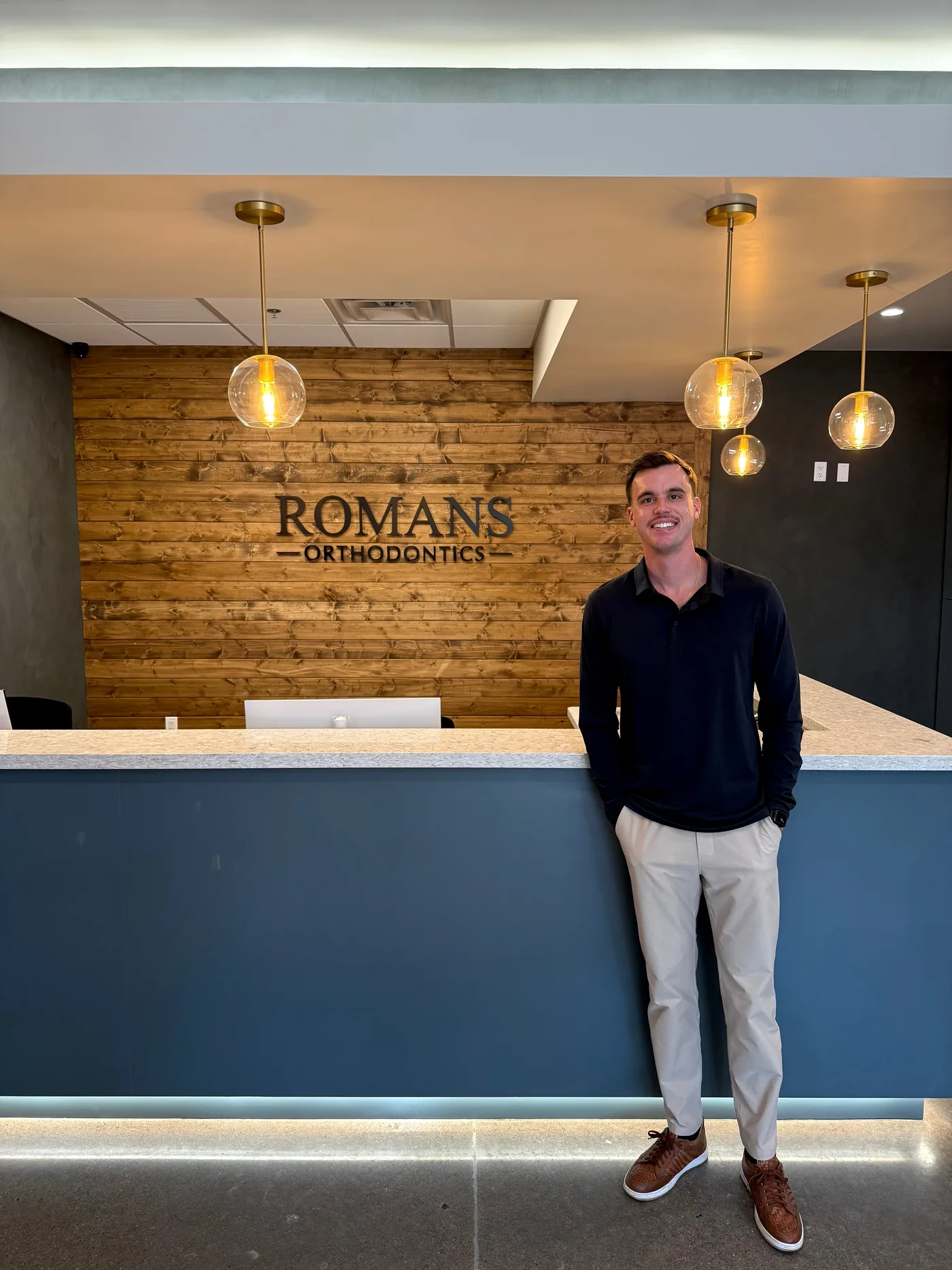 Dr. Nicholas Romans at the reception desk of his practice in Anthem, Arizona